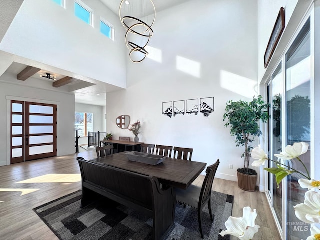 dining area with a high ceiling and wood finished floors