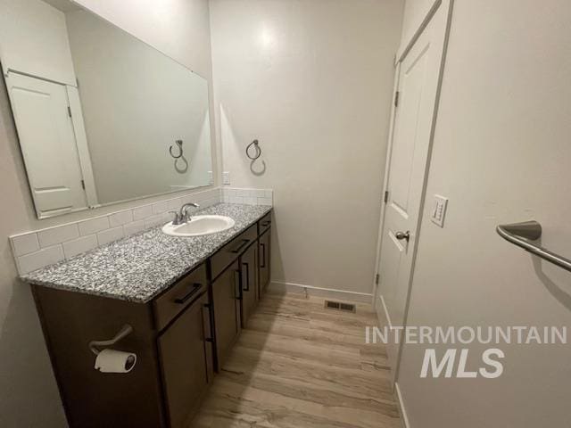 bathroom with vanity and wood-type flooring