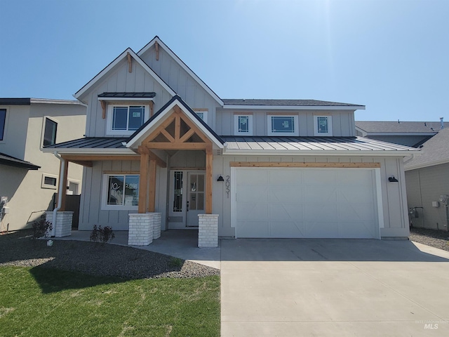 view of front of property with a standing seam roof, board and batten siding, concrete driveway, and metal roof