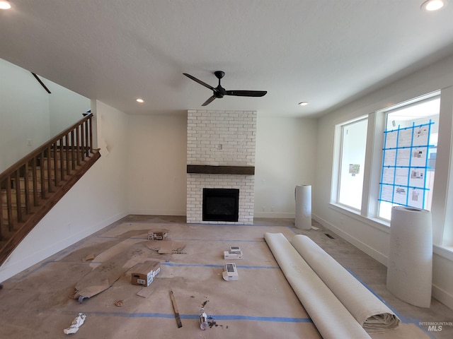 unfurnished living room featuring baseboards, recessed lighting, ceiling fan, and stairway