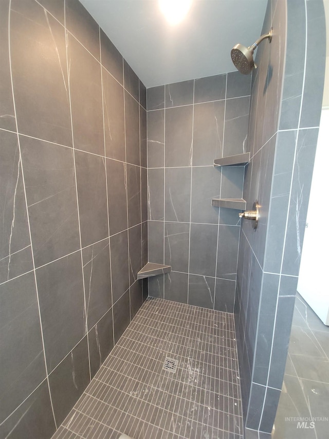 bathroom with tiled shower
