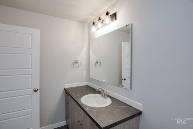 bathroom with vanity and baseboards