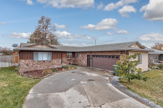 ranch-style house featuring a front yard and a garage