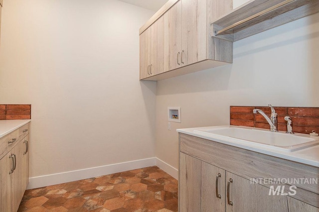 laundry area with sink, cabinets, and washer hookup