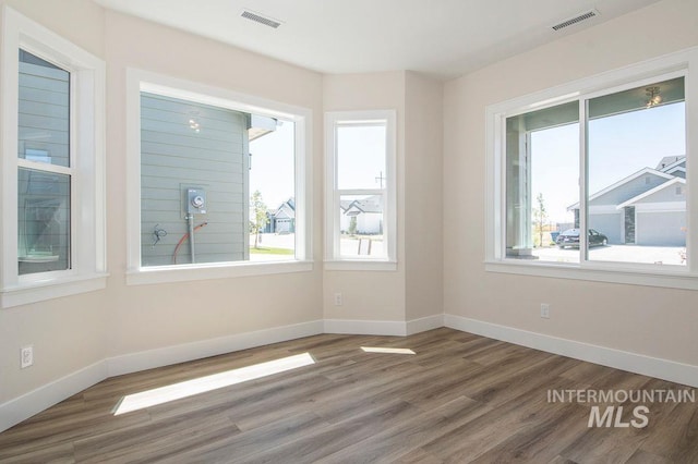 unfurnished room with hardwood / wood-style floors