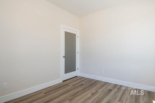 empty room with hardwood / wood-style floors