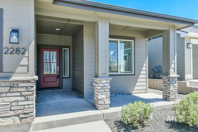 view of exterior entry featuring a porch