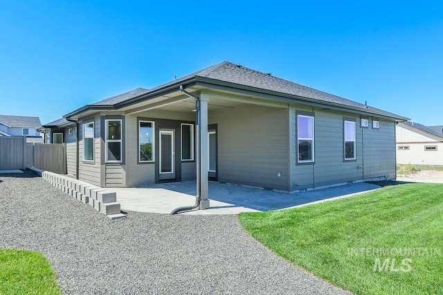 rear view of property with a patio area and a lawn