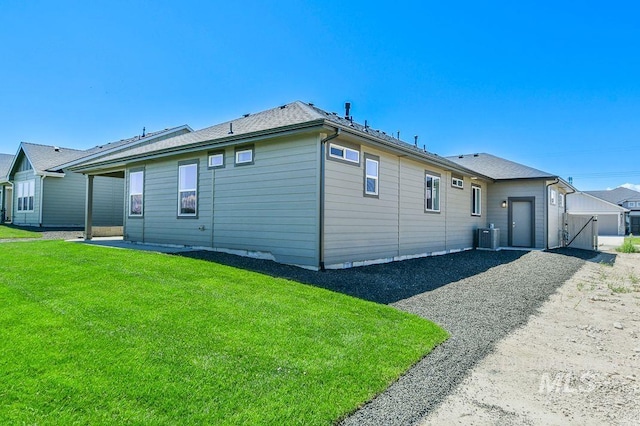 rear view of property with a yard