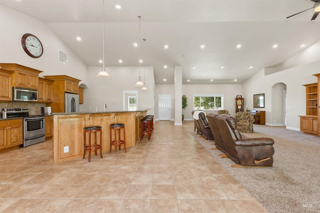 2790 S Mcdermott Rd, Nampa, ID 83687 - living room with high vaulted ceiling, recessed lighting, arched walkways, light tile patterned floors, and ceiling fan