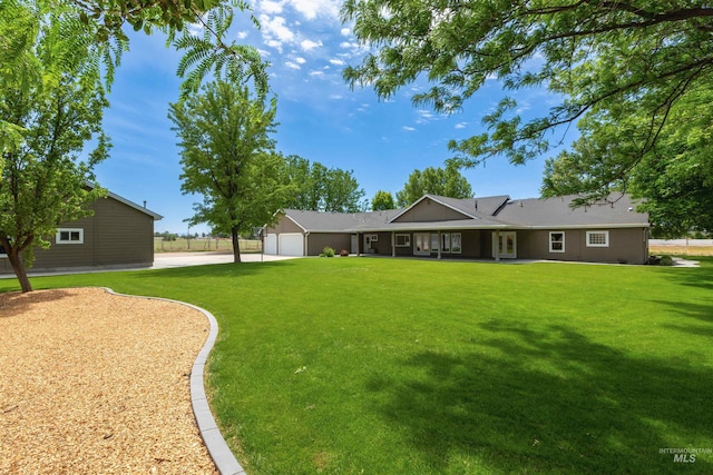 2790 S Mcdermott Rd, Nampa, ID 83687 - rear view of house with a garage, a lawn, and driveway
