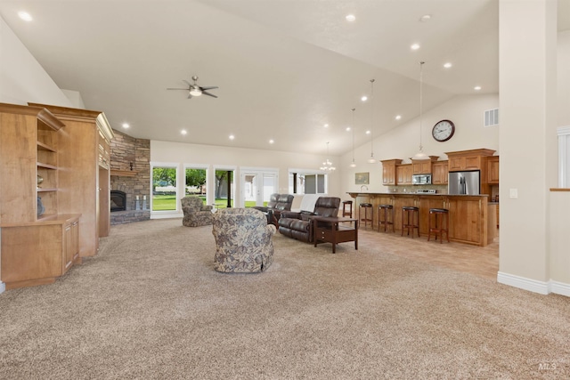 2790 S Mcdermott Rd, Nampa, ID 83687 - living area featuring light colored carpet, a ceiling fan, a fireplace, high vaulted ceiling, and recessed lighting