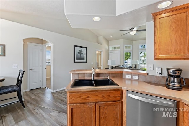 3918 Fallwood Cir, Caldwell, ID 83607 - kitchen featuring dishwasher, a sink, vaulted ceiling, light wood-style flooring, and light countertops