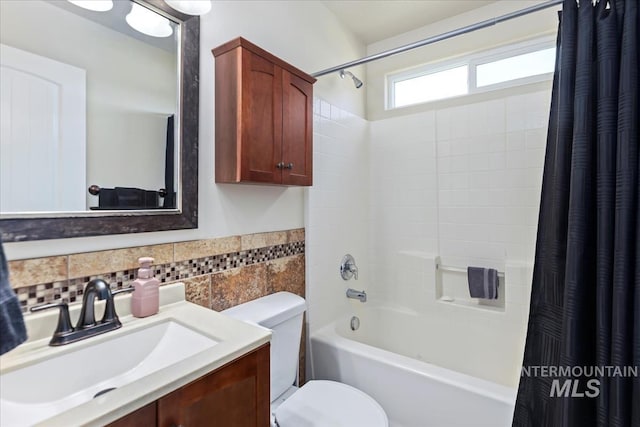 3918 Fallwood Cir, Caldwell, ID 83607 - bathroom featuring shower / tub combo with curtain, toilet, vanity, tile walls, and wainscoting