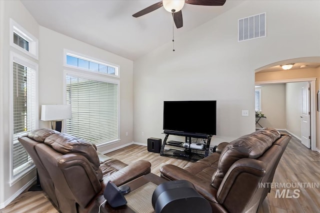 3918 Fallwood Cir, Caldwell, ID 83607 - living area with arched walkways, a ceiling fan, light wood-type flooring, high vaulted ceiling, and baseboards
