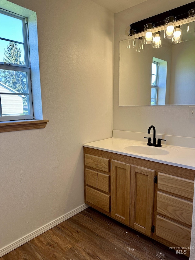 408 Walnut St, Nezperce, ID 83543 - bathroom featuring vanity, baseboards, and wood finished floors