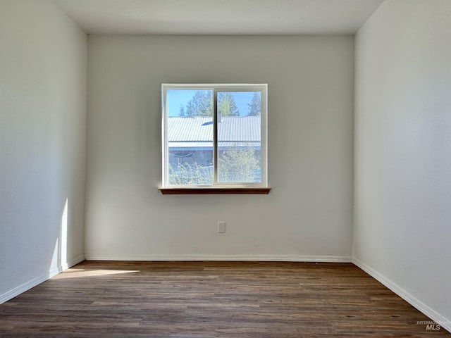 408 Walnut St, Nezperce, ID 83543 - empty room with baseboards and dark wood-type flooring