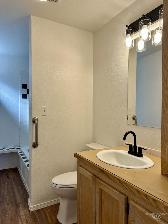 408 Walnut St, Nezperce, ID 83543 - bathroom with vanity, a textured wall, wood finished floors, toilet, and baseboards