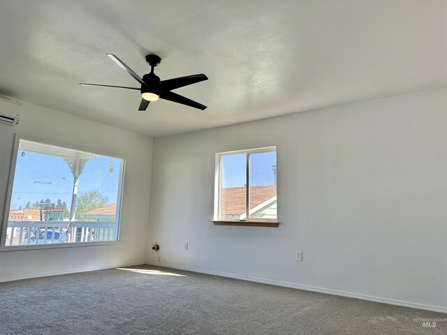 408 Walnut St, Nezperce, ID 83543 - carpeted spare room featuring baseboards, a ceiling fan, and an AC wall unit