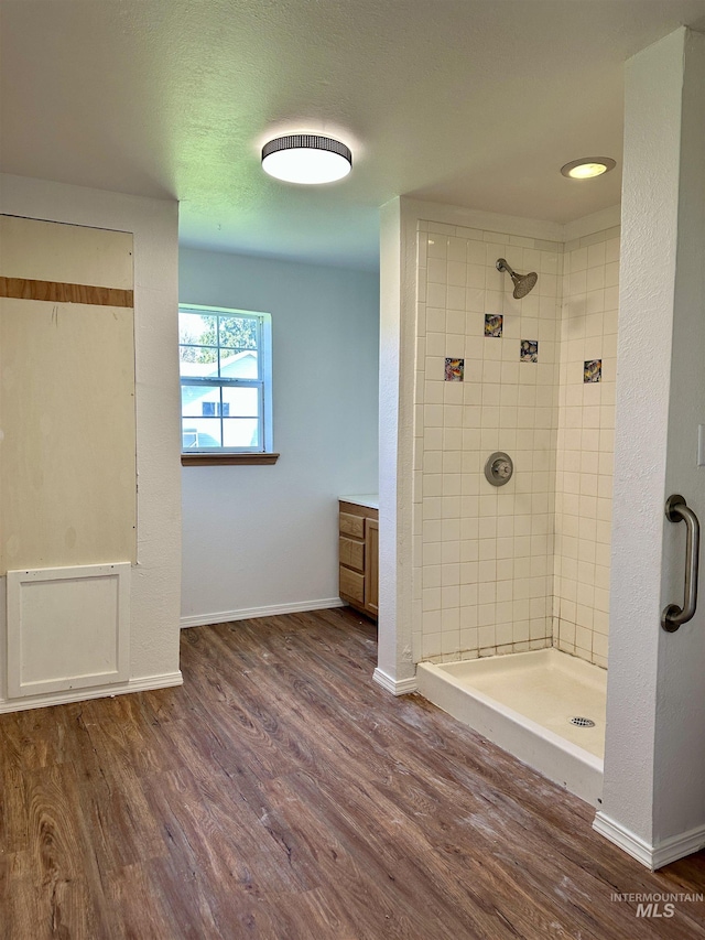 408 Walnut St, Nezperce, ID 83543 - full bathroom featuring baseboards, a stall shower, and wood finished floors