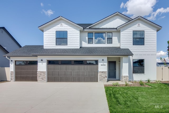 view of front of home with a garage and a front lawn