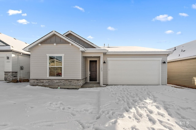 view of front of house featuring a garage, stone siding, and board and batten siding