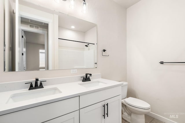 full bathroom with walk in shower, a sink, toilet, and double vanity