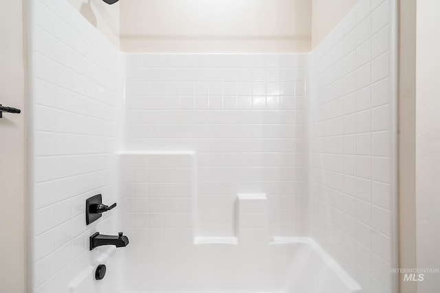 interior details featuring shower / bathtub combination