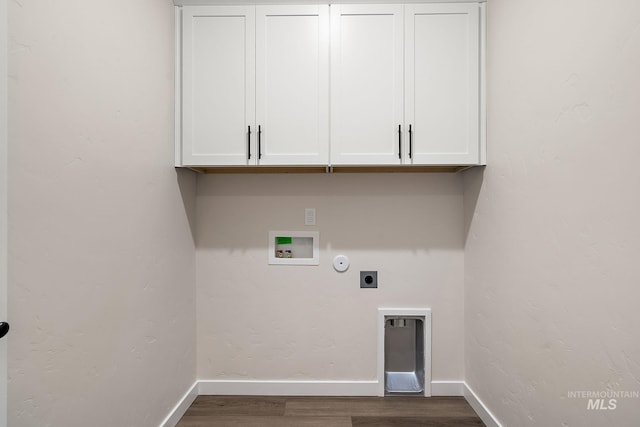 washroom with hookup for a washing machine, cabinet space, electric dryer hookup, wood finished floors, and baseboards