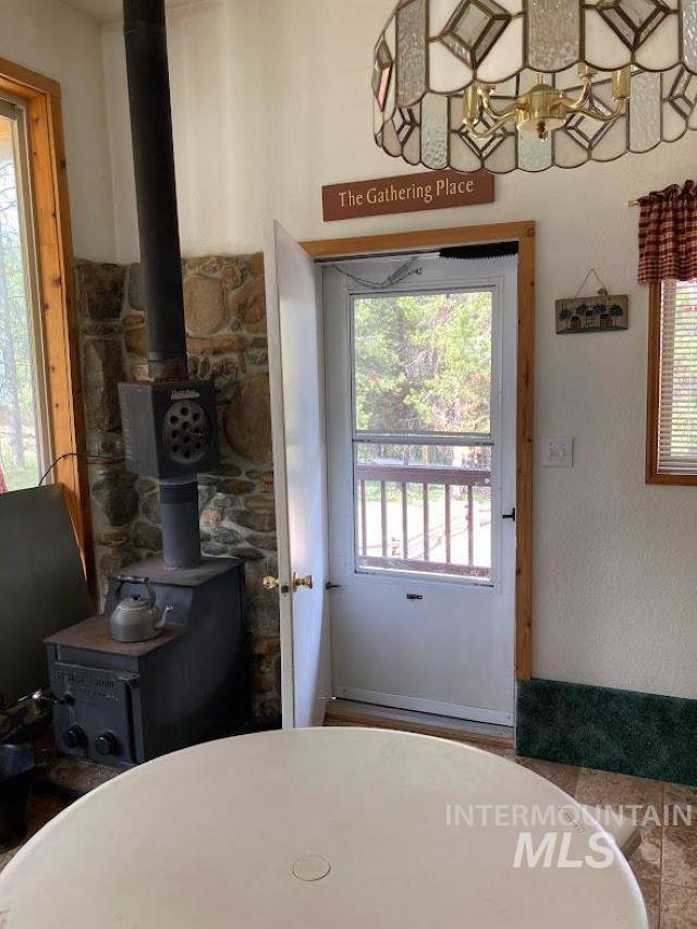 doorway to outside with a wood stove