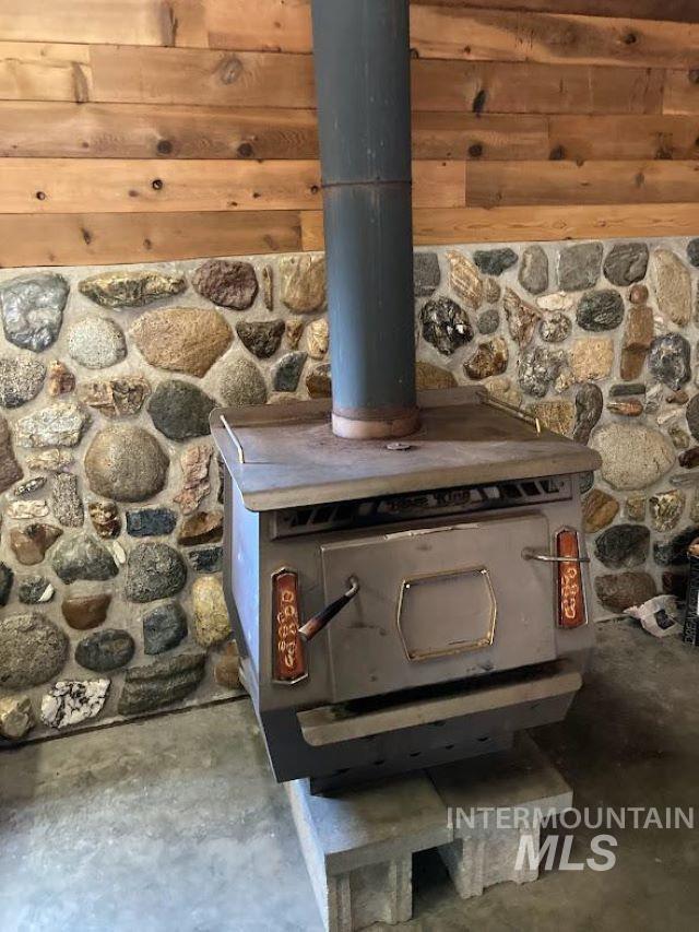 details featuring concrete floors and a wood stove