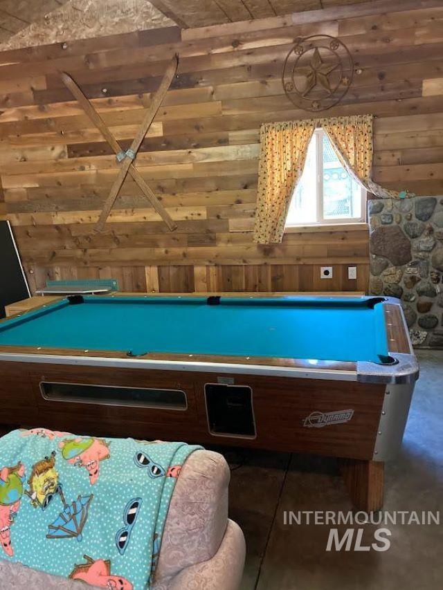 recreation room with billiards and wood walls