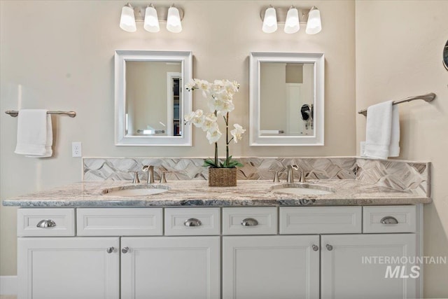 bathroom with a sink and double vanity