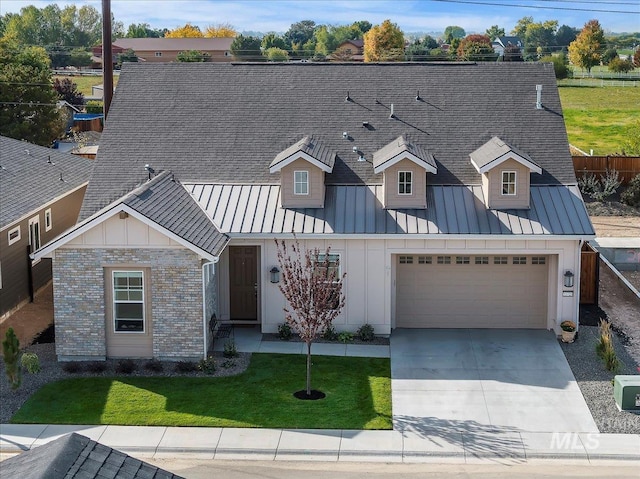 view of front of home with brick siding, board and batten siding, a garage, driveway, and a standing seam roof