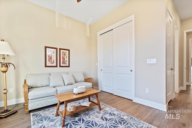 living room with baseboards and wood finished floors