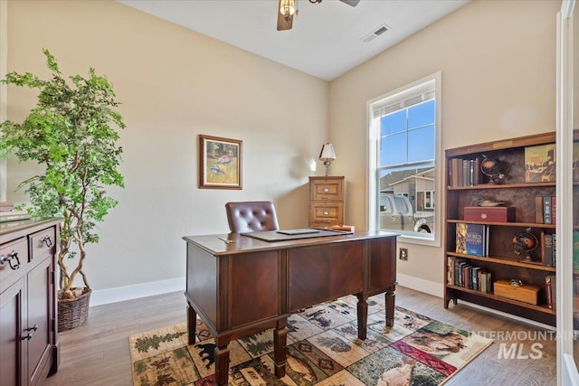 office featuring visible vents, baseboards, a ceiling fan, and wood finished floors