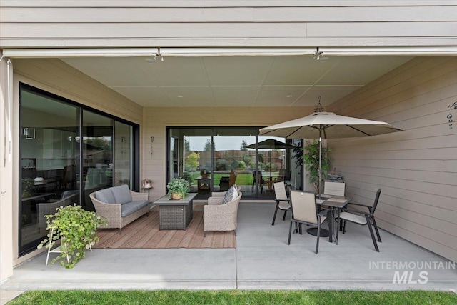 view of patio featuring an outdoor hangout area, outdoor dining space, and a deck