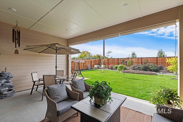 view of patio / terrace featuring outdoor dining area and fence