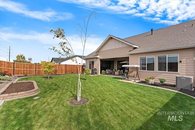 view of yard with an outdoor living space, central air condition unit, a patio, and fence