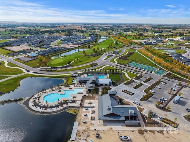 drone / aerial view featuring view of golf course and a water view