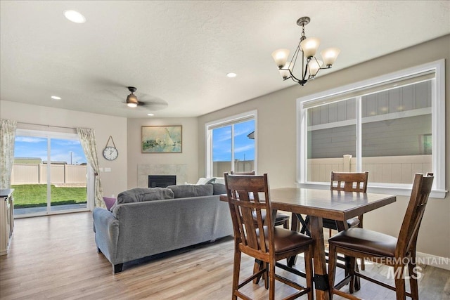 11638 W Quintale Dr, Nampa, ID 83686 - dining space with light wood-style floors, a ceiling fan, recessed lighting, plenty of natural light, and a textured ceiling