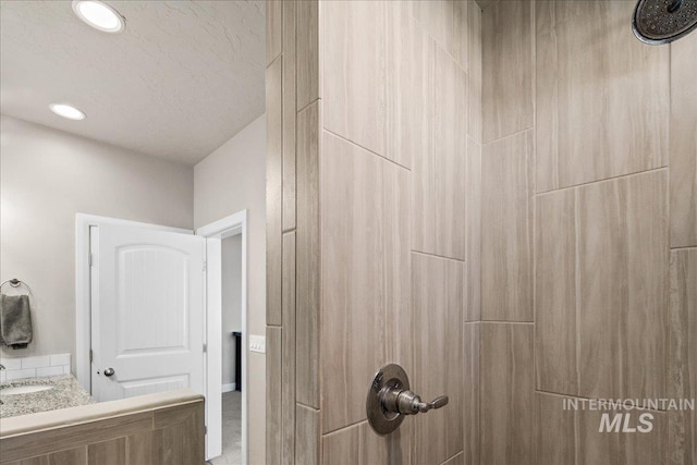 11638 W Quintale Dr, Nampa, ID 83686 - bathroom with tiled shower, recessed lighting, and vanity