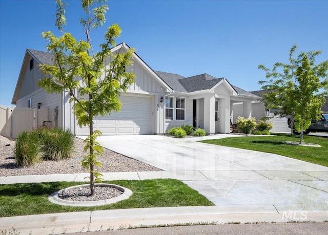11638 W Quintale Dr, Nampa, ID 83686 - ranch-style house with board and batten siding, driveway, an attached garage, and a front lawn