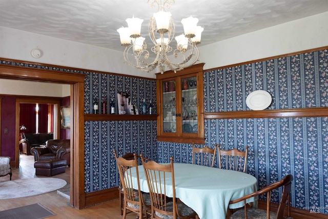 2771 S 850 E, Hagerman, ID 83332 - dining space featuring a chandelier, wood finished floors, and wallpapered walls