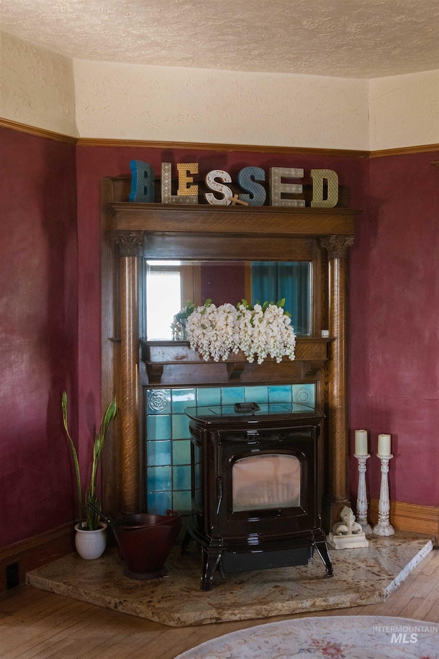 2771 S 850 E, Hagerman, ID 83332 - detailed view of a wood stove, wood finished floors, and a textured wall