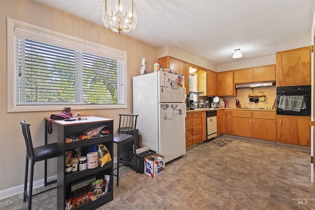 kitchen with hanging light fixtures, baseboards, a notable chandelier, light countertops, and black appliances