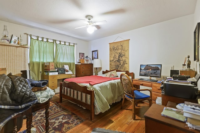 bedroom featuring hardwood / wood-style floors and a ceiling fan