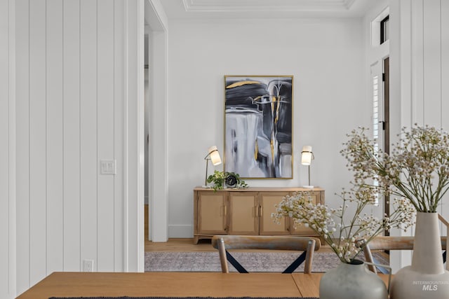 sitting room featuring wood finished floors and crown molding