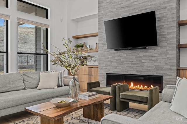 living room featuring a large fireplace