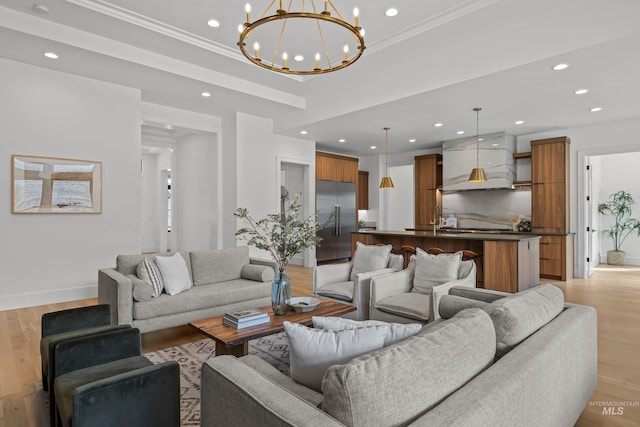 living room with recessed lighting, an inviting chandelier, crown molding, and light wood-style floors